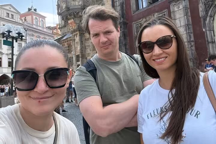Three friends taking a selfie near Prague Old Town Square during a self-guided walking tour escape game adventure