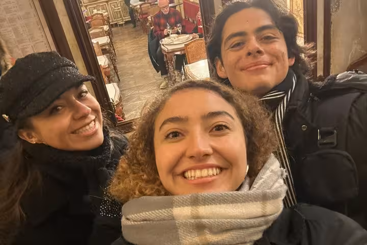 Friends smiling inside a historic Venetian cafe during the Casanova self-guided romance walking tour