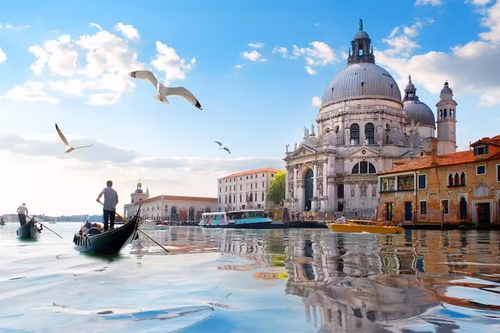 Gondola gliding past Santa Maria della Salute on Venice Grand Canal self-guided Casanova romance tour