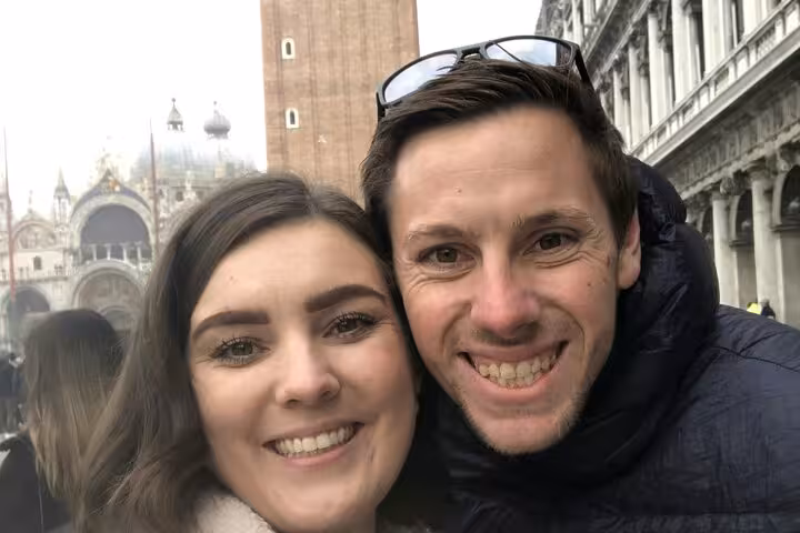 Happy couple taking a selfie at St. Mark's Square during the Casanova romantic self-guided walking tour Venice