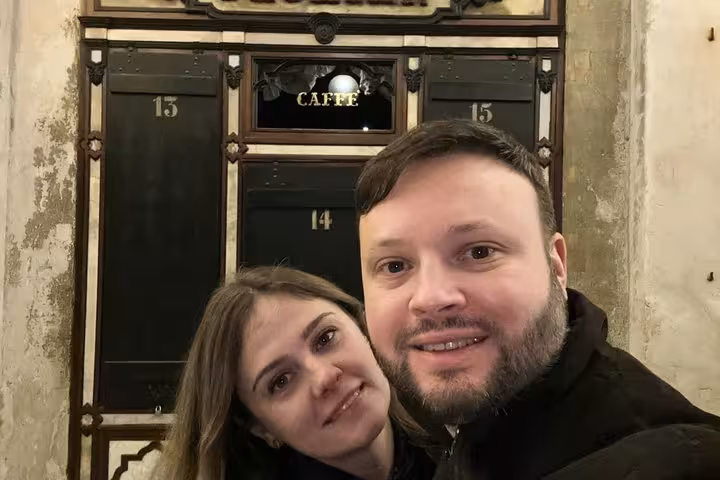Couple smiling at a historic Venetian caffè during a Casanova self-guided romance walking tour in Venice