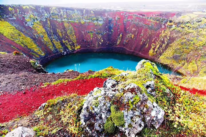 Gullfoss waterfall cascading into a misty canyon with moss-covered cliffs on Iceland's Golden Circle