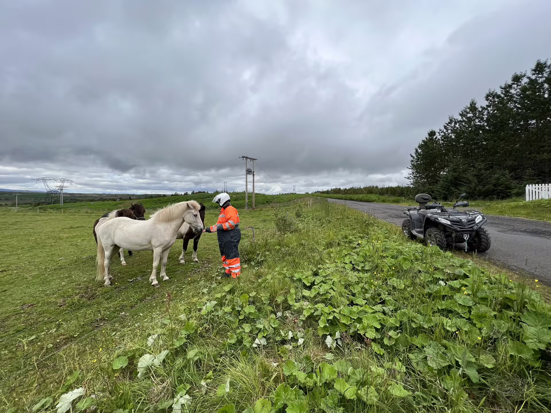 ATV quad bikes riding on a scenic trail near Reykjavik with a helmeted rider in the foreground