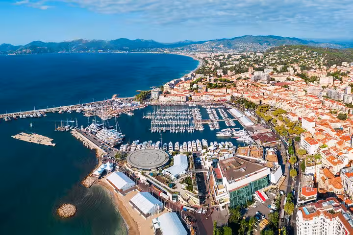 Passenger photographing Mediterranean coastline from helicopter during private Cannes tour