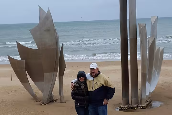 Family group posing at D-Day Normandy beach overlook on private tour from Le Havre