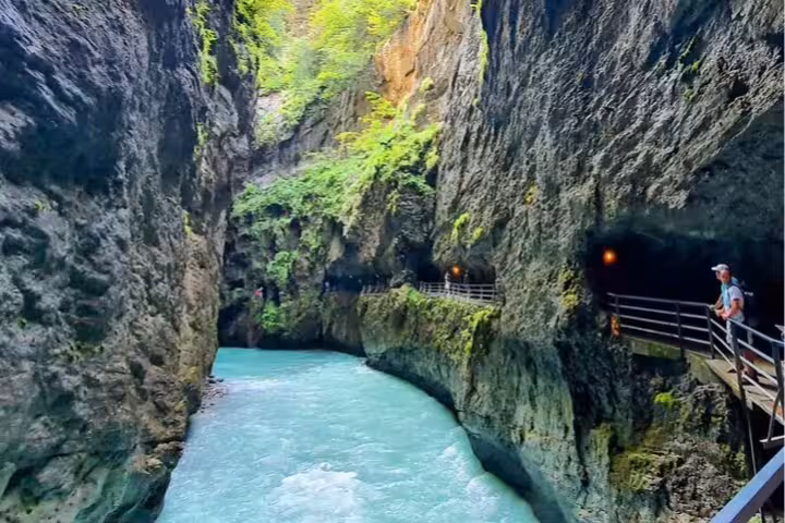 Stunning view of turquoise river flowing through Aare Gorge, highlighting scenic trails on Swiss private tour.