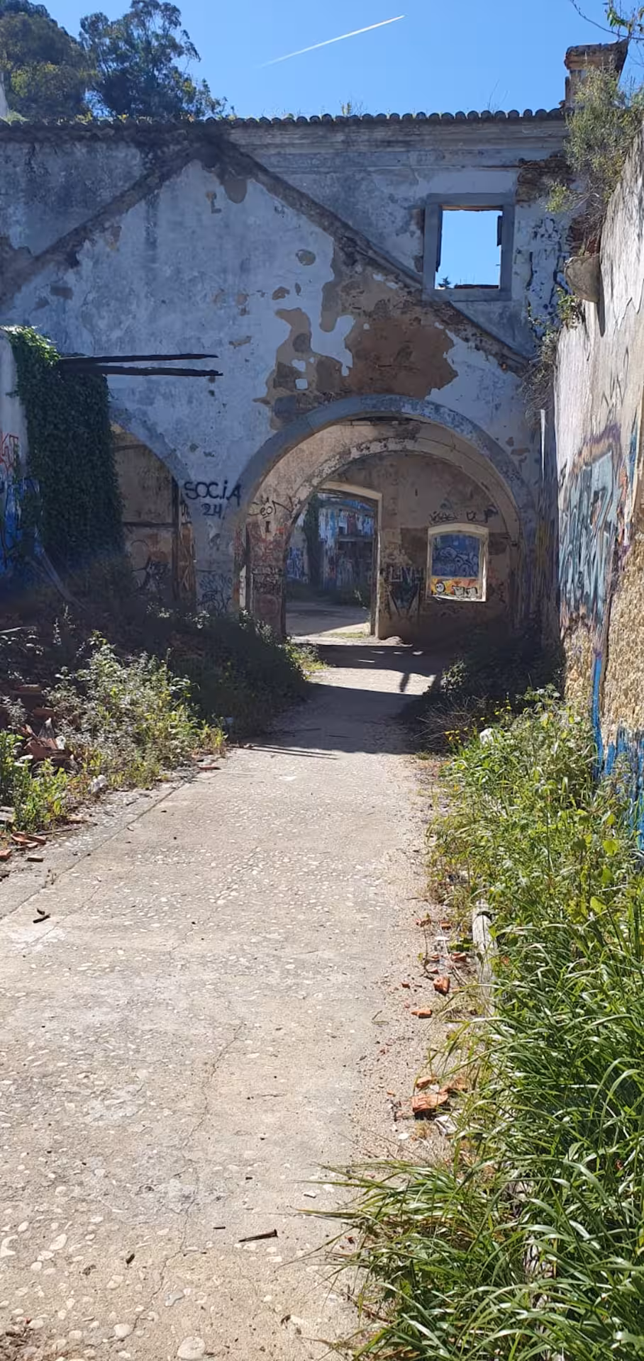Abandoned graffiti-covered archway in Almada, offering a glimpse into urban exploration near Lisbon.