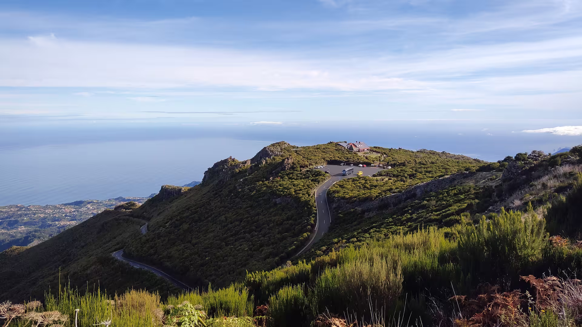 Scenic view of winding road and ocean from a mountaintop on Above the Skies' Hike adventure.