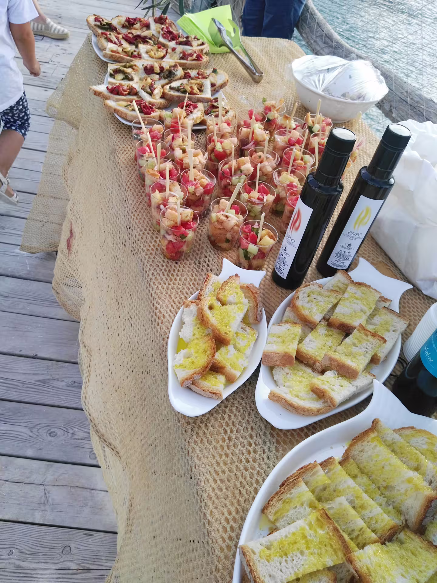 Abruzzo olive oil tasting table with EVOO bottles, bruschetta and appetizers for a local food experience