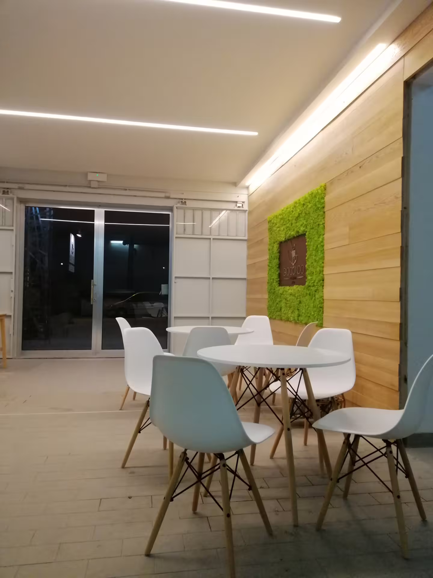 Modern Abruzzo olive oil tasting room at local mill, minimalist tables and chairs for guided EVOO sampling