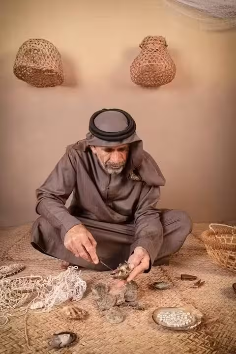 Local Emirati man demonstrating traditional pearl diving craft, an authentic cultural experience on Abu Dhabi tour