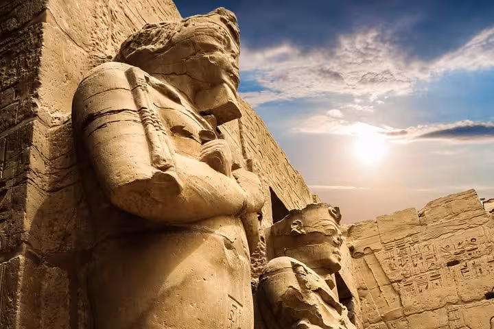 Close-up of Abu Simbel colossal statues at sunset, VIP day tour with flight from Aswan, Egypt