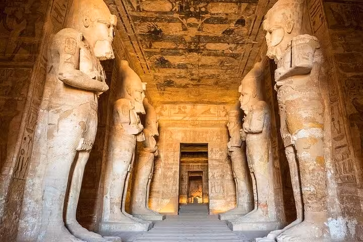 Inside Abu Simbel Great Temple hypostyle hall with colossal statues, private full-day tour from Aswan