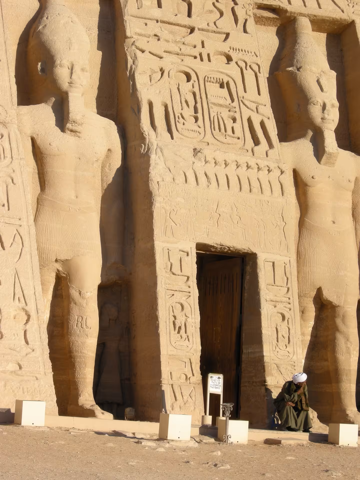 Entrance of Abu Simbel Small Temple with giant rock-cut statues and hieroglyphics, Aswan Egypt