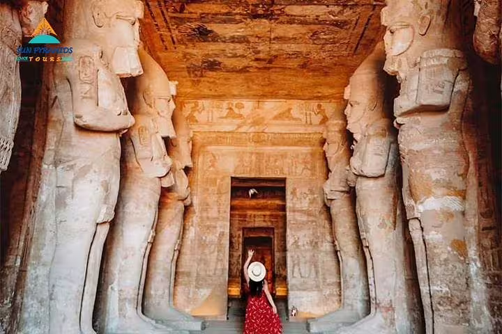 Traveler in Abu Simbel Great Temple colonnade, highlight of 8 days 7 nights Egypt tour Luxor and Aswan