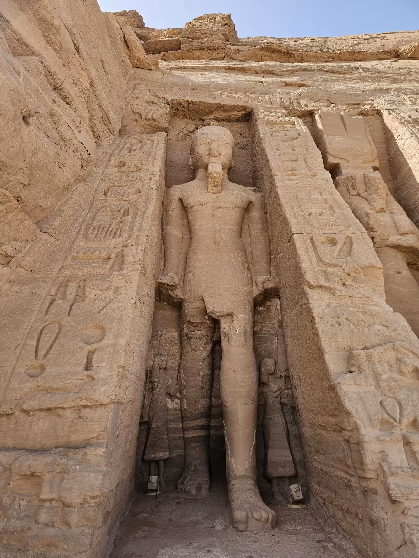 Colossal standing statue of Ramesses II carved into the facade of Abu Simbel Temple, Aswan, Egypt