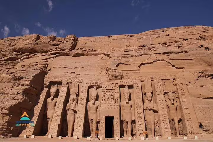 Abu Simbel Temple statues carved in sandstone cliff, highlight of Luxor to Aswan day tour in Egypt