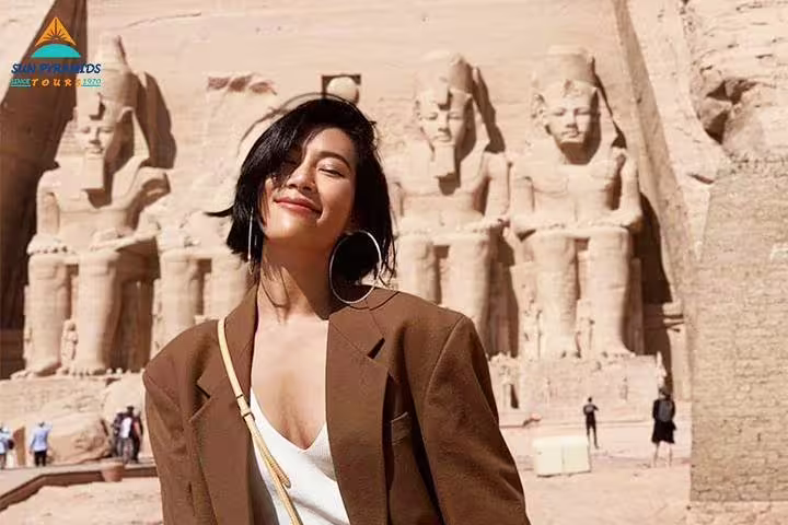 Smiling traveler at Abu Simbel temples near Aswan, must-see on 12 days Cairo Luxor Aswan Petra package