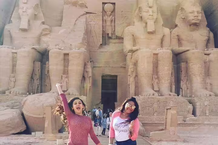 Happy travelers at Abu Simbel temples on a private tour from Aswan with guide and transfers included