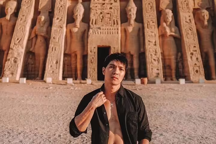 Close-up traveler at Abu Simbel temples from Aswan, private guided tour with hotel transfers in Egypt