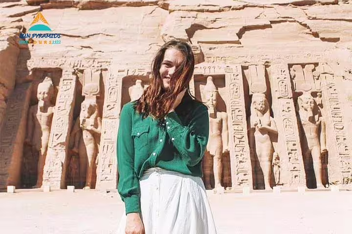 Tourist by carved pillars at Abu Simbel temples, Egypt Nile and Nubia highlights on 8 days 7 nights road trip