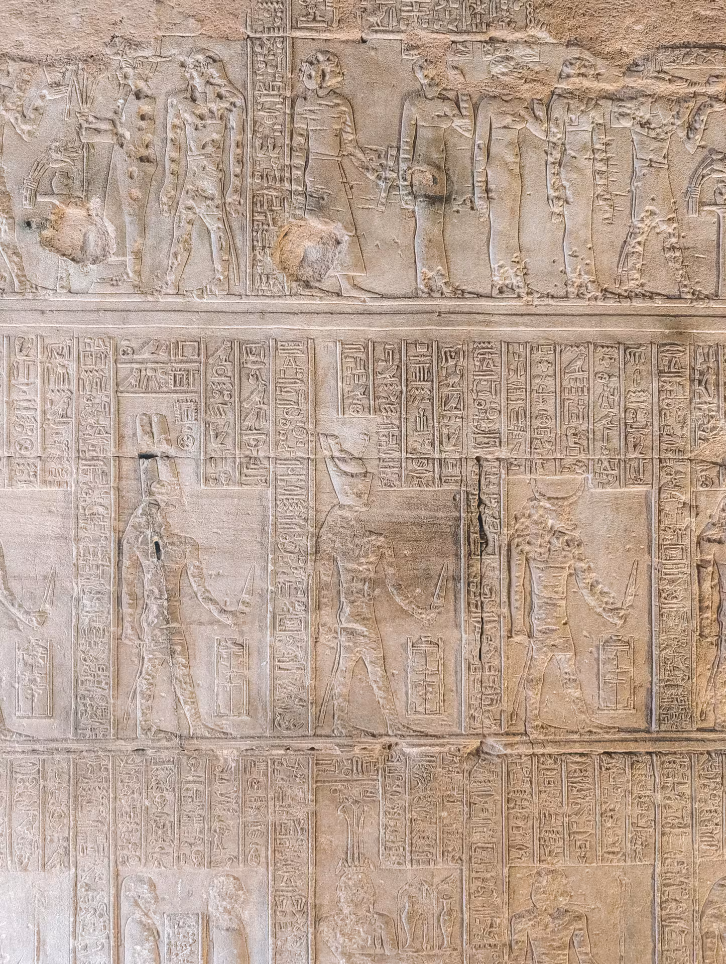 Detailed ancient Egyptian god relief carvings and hieroglyphs on Abydos Temple walls visited from Safaga