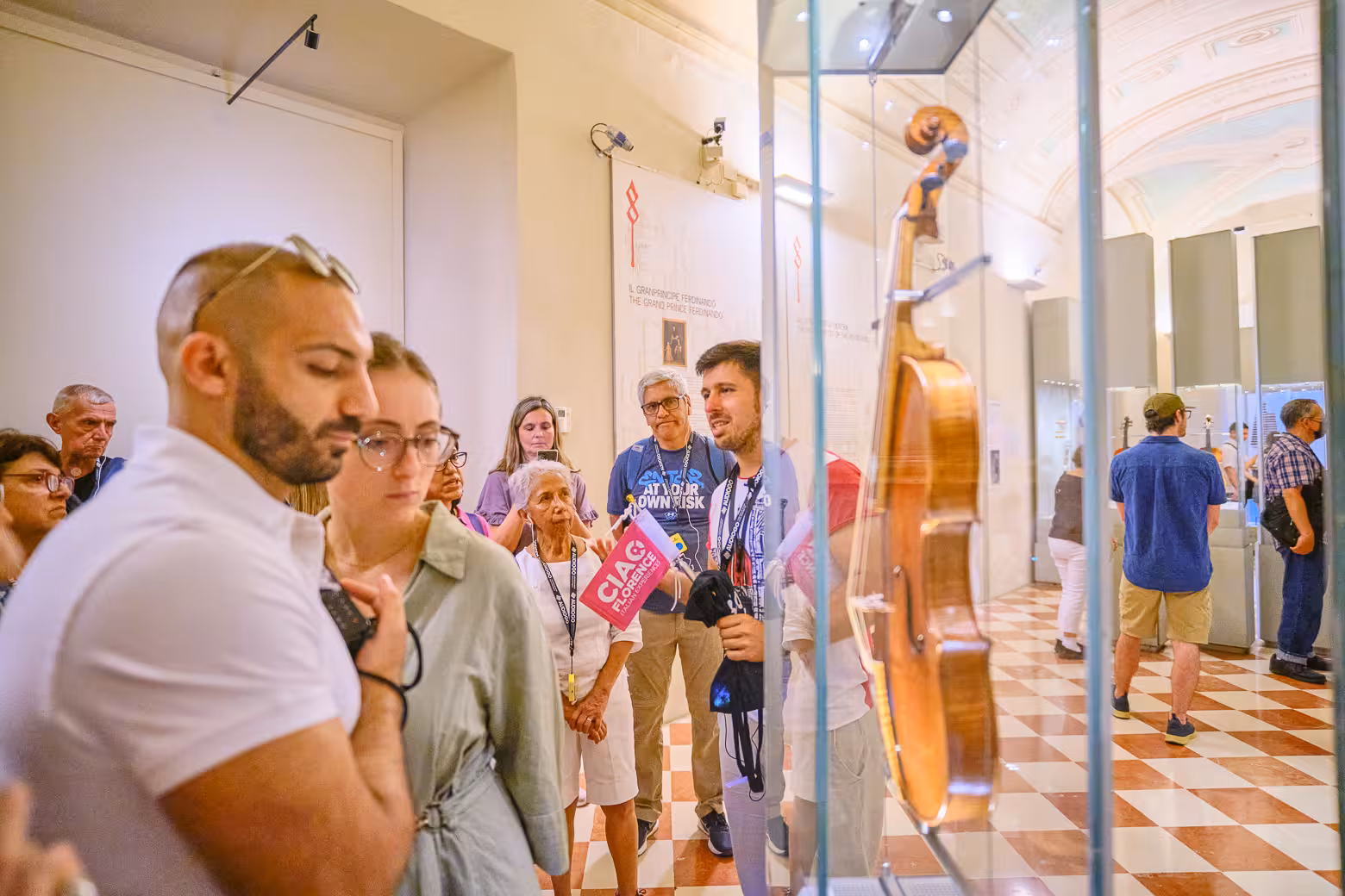 A tour group explores musical instruments at Accademia Gallery on a guided tour in Florence.