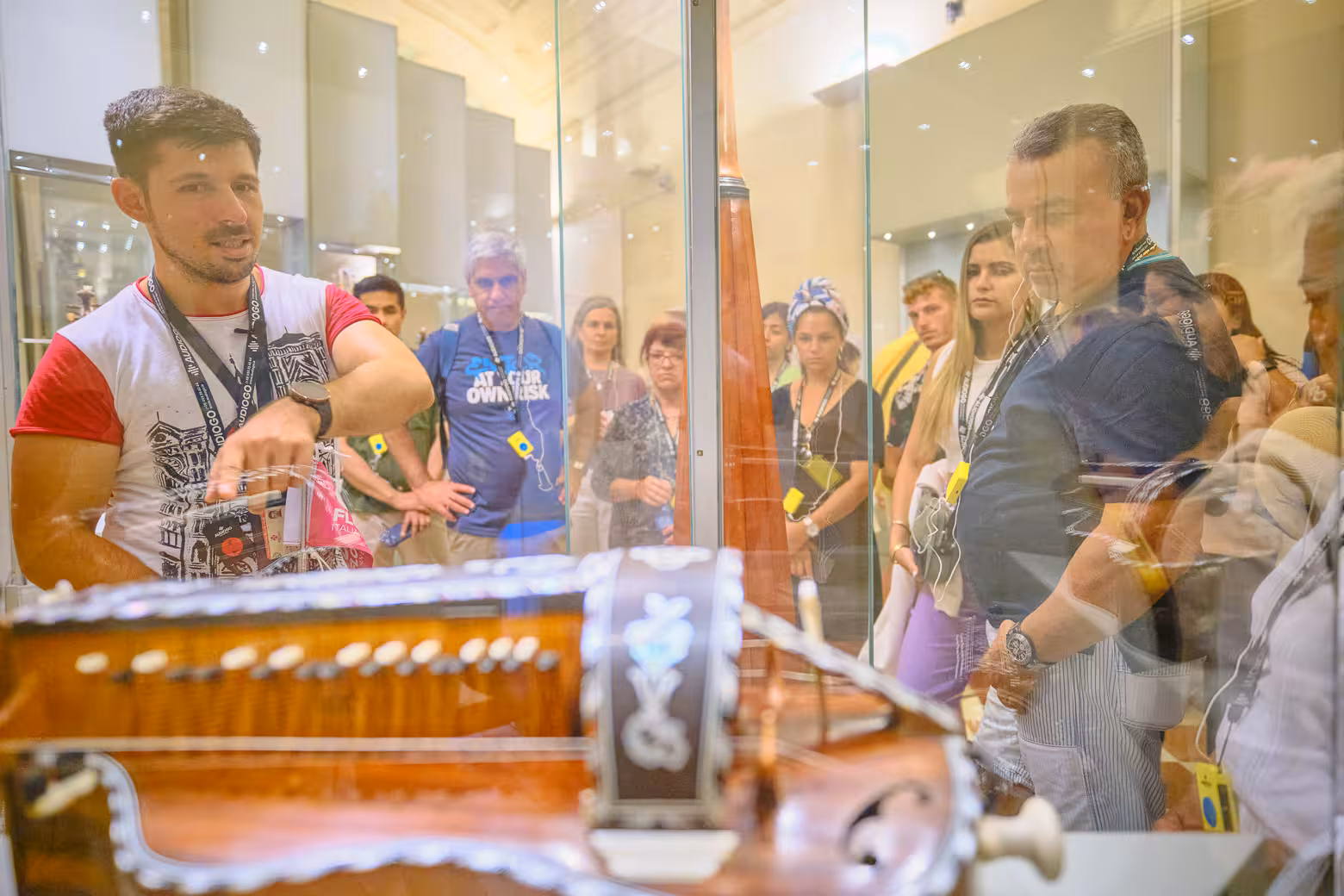 Tour group explores Accademia Gallery's musical instrument exhibit during a guided skip-the-line tour in Florence.