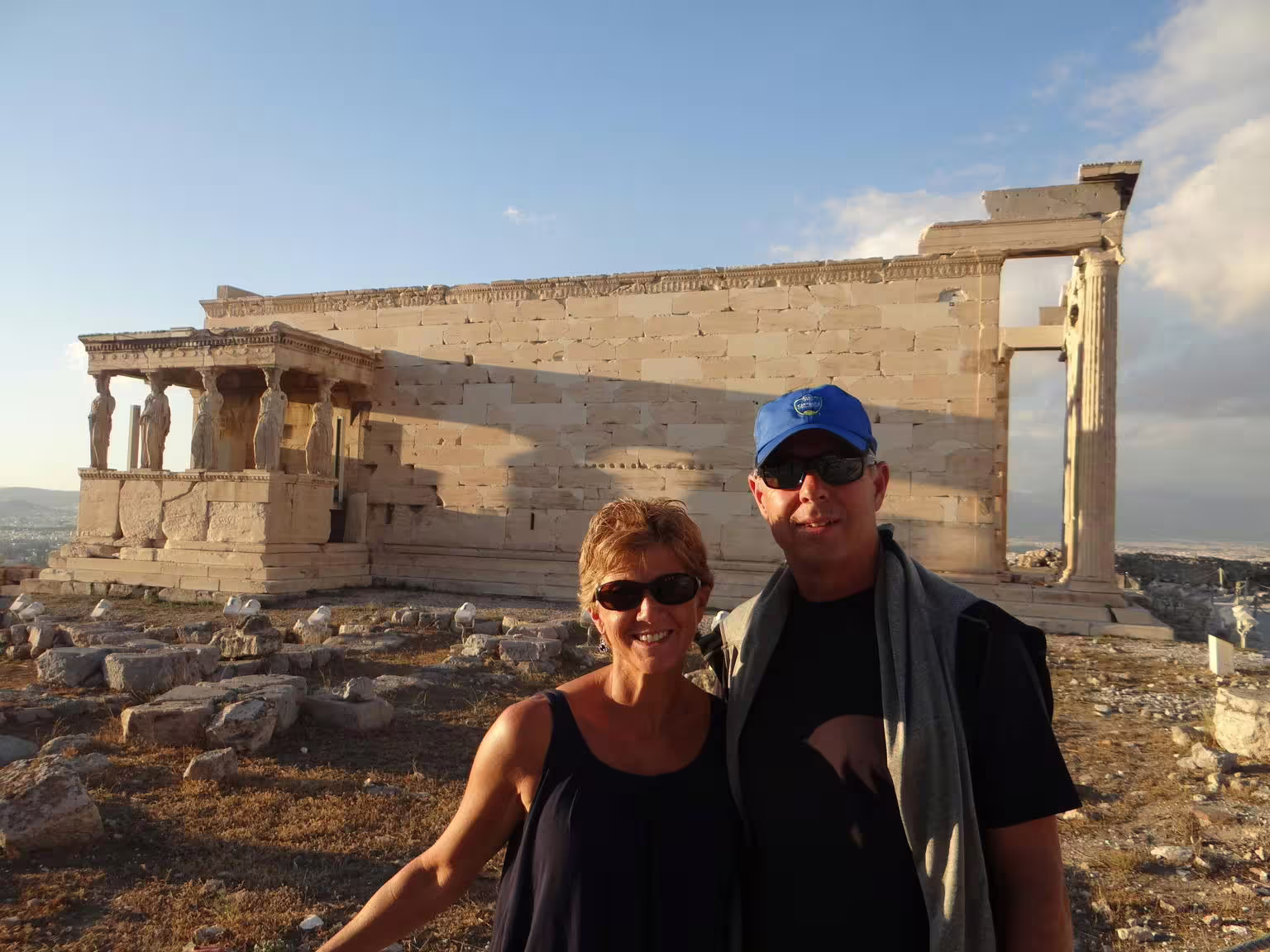 Visitors posing by Erechtheion on Acropolis of Athens at sunset, skip-the-line guided walking tour