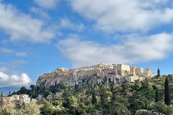 Acropolis of Athens on rocky hilltop under blue sky, highlight of a private luxury half-day Athens tour