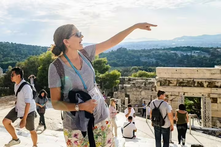 Tour guide pointing out Acropolis landmarks on Athens Parthenon walking tour with panoramic city views