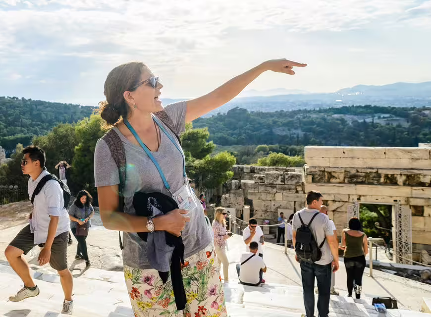 Tour guide pointing out landmarks on Acropolis of Athens, skip-the-line walking tour with panoramic views
