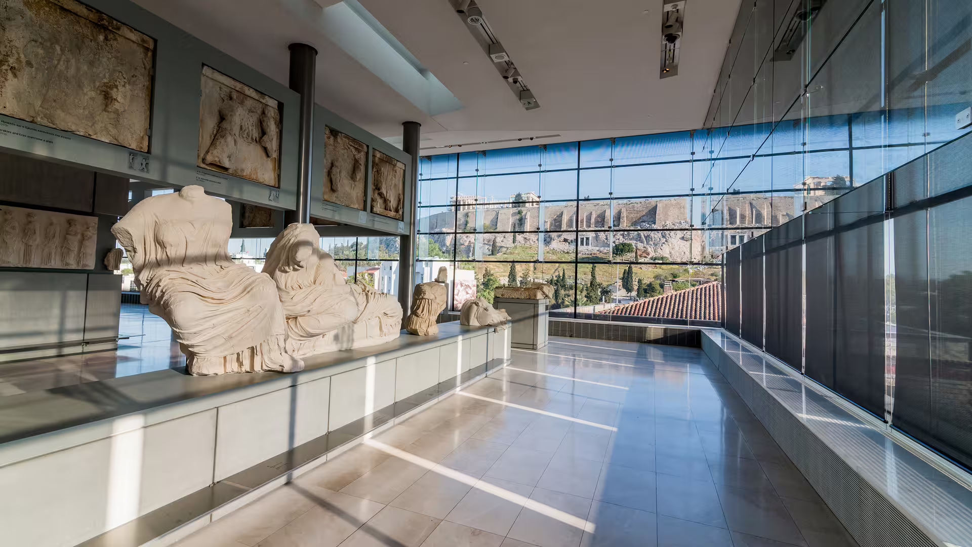 Acropolis Museum gallery with ancient statues and Acropolis view, Athens private tour guide city center visit