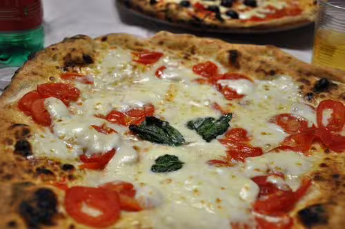Close-up of Margherita pizza on a table, a tasty meal break after an Acropolis afternoon tour in Athens