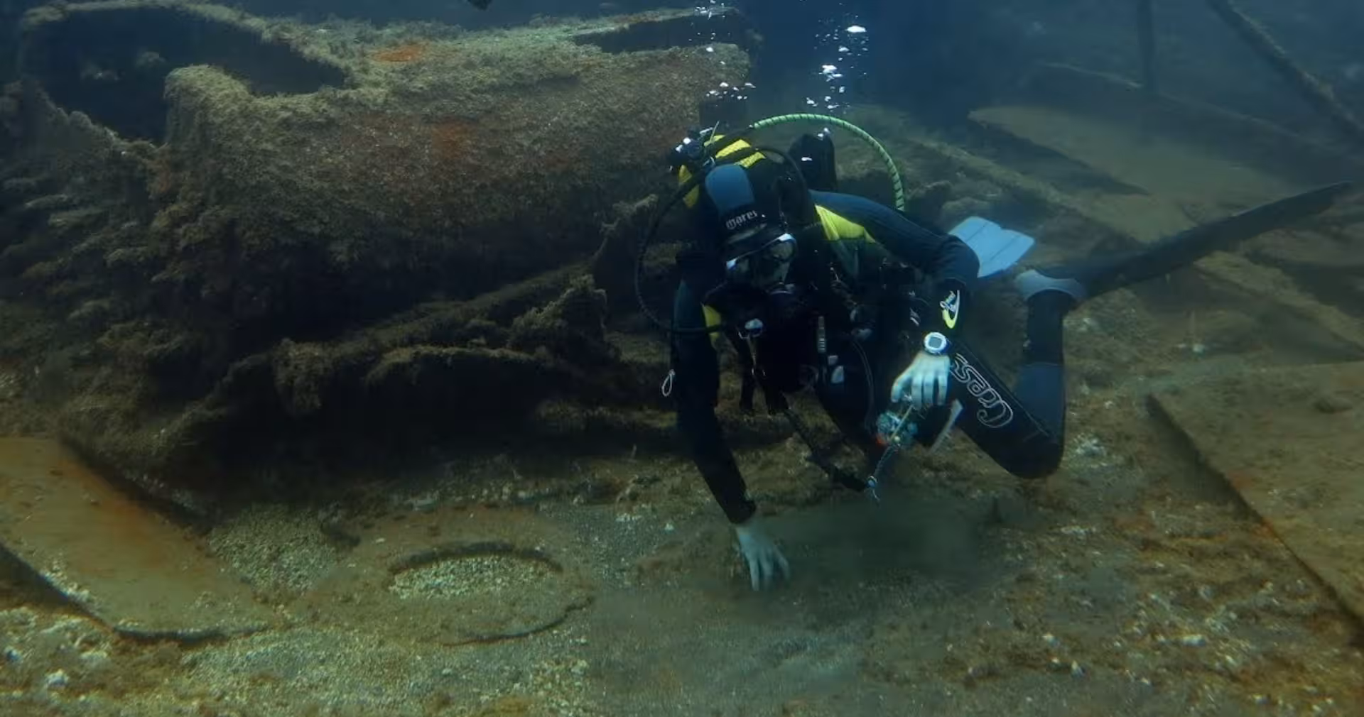 Advanced Open Water Diver explores a sunken wreck, practicing buoyancy control and underwater navigation skills