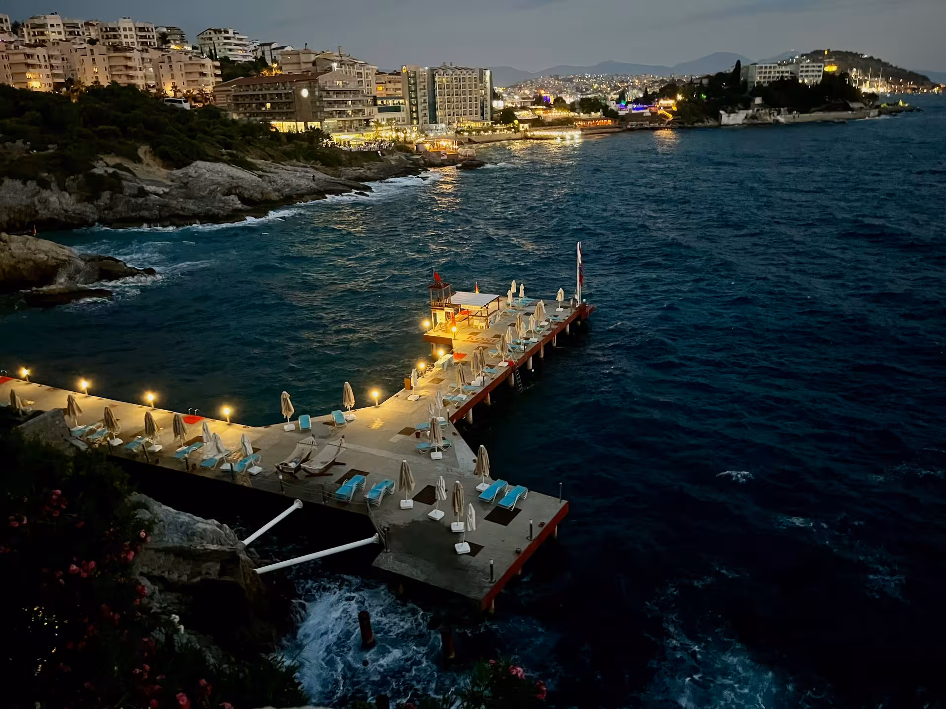 Aegean coast at dusk with seaside pier and city lights, scenic stop on a Highlights of Turkey tour
