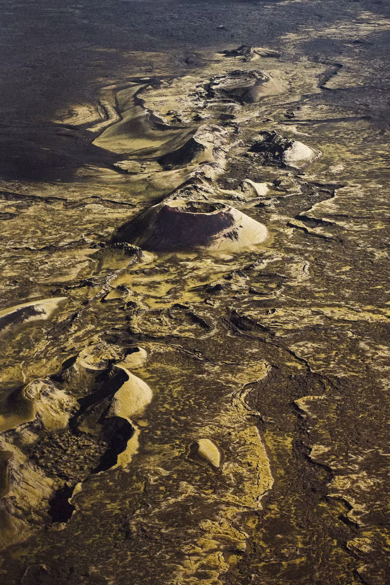 Aerial view of volcanic craters and lava fields in Iceland seen from helicopter tour