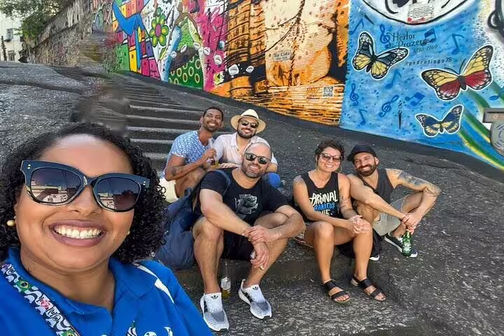 Group of tourists enjoying vibrant street art in Rio's Little Africa, highlighting Afro-Brazilian culture and heritage.