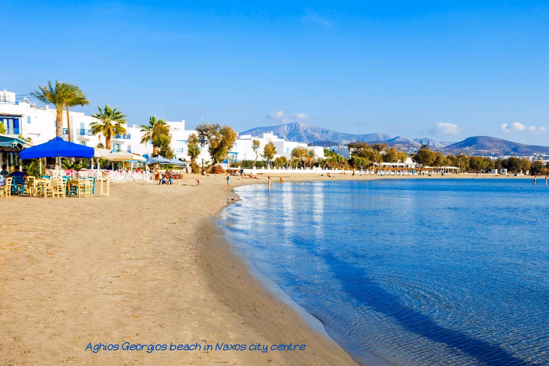 Agios Georgios Beach, Naxos Town waterfront with cafes and calm sea, part of Athens island hopping to Santorini and Mykonos