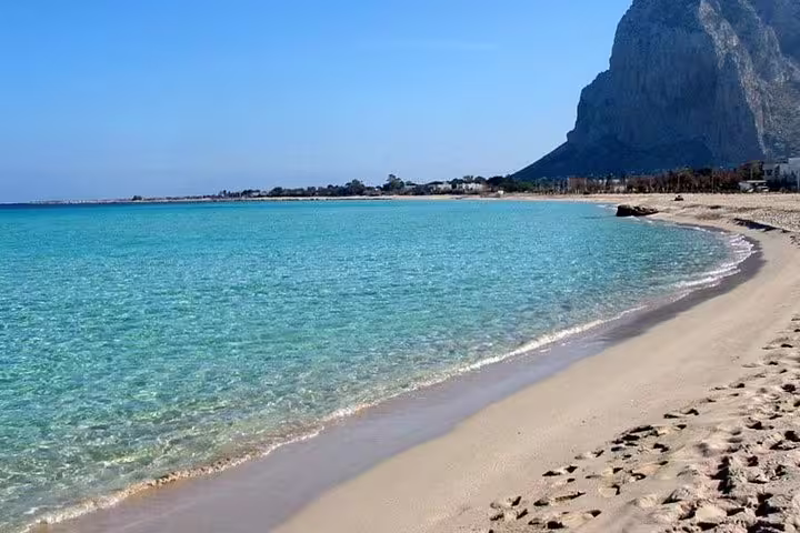 Crystal-clear turquoise sea and golden sand beach near Agrigento on a sunny private day trip from Palermo, Sicily