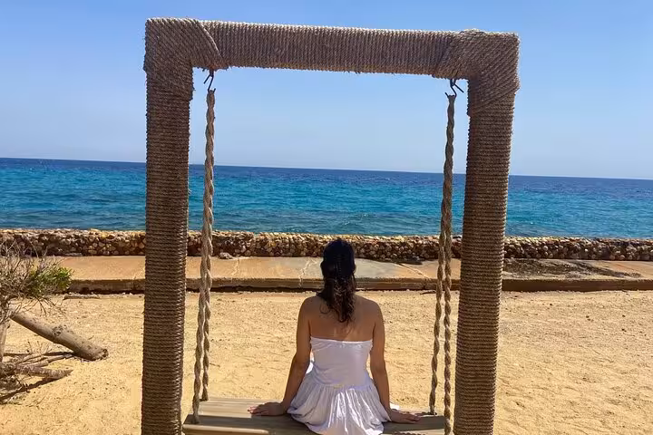 Seaside swing overlooking turquoise Red Sea at Ain El Sokhna, scenic photo spot on Cairo day trip tour