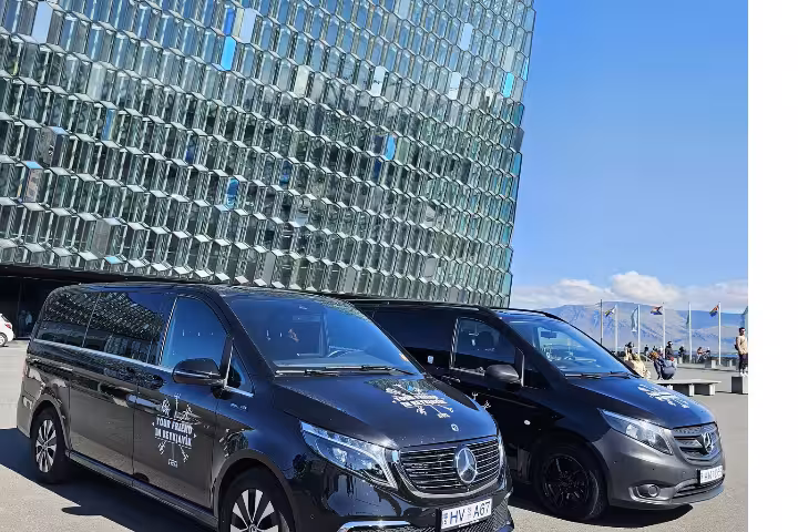 Two vans parked in front of the Harpa Concert Hall in Reykjavik