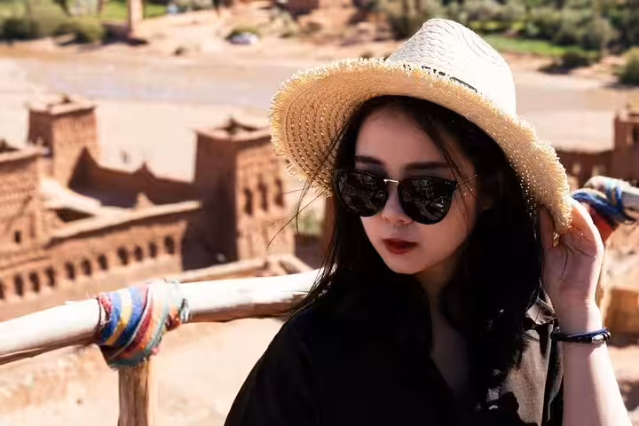 Traveler overlooking Ait Benhaddou kasbah near Ouarzazate, stop on a 9-day Morocco tour from Casablanca