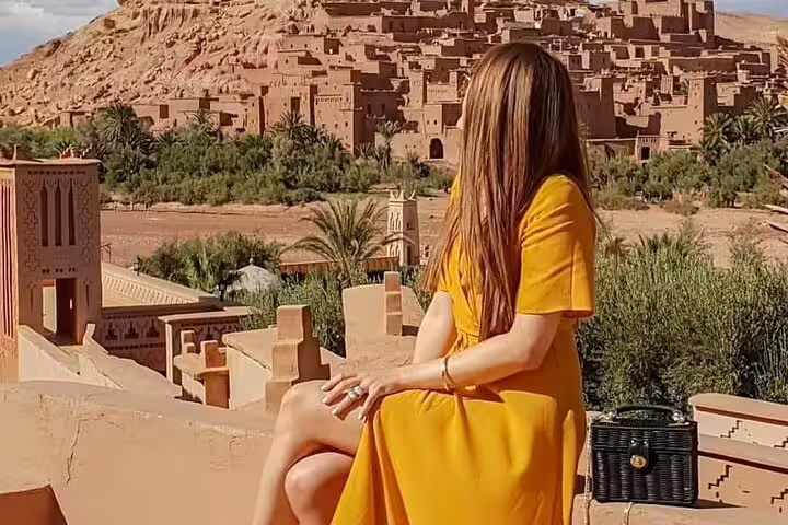 Traveler overlooking Ait Benhaddou kasbah near Ouarzazate on Morocco 9 days tour from Marrakech itinerary