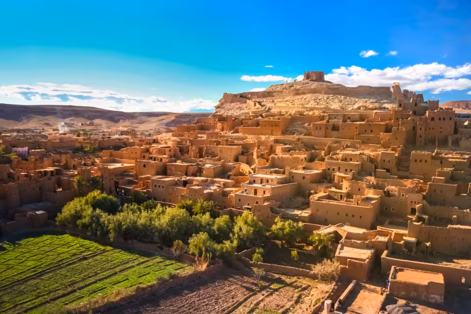 Picturesque Ait Benhaddou village with lush greenery and historic architecture on the Sahara tour route.