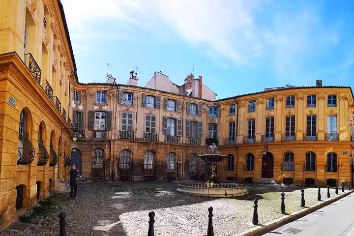 Historic Aix-en-Provence courtyard with fountain and ochre facades on a private full-day shore excursion from Arles