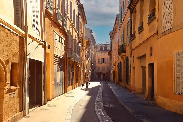 Charming sunlit street in Aix-en-Provence showcasing historic architecture on a guided intro walk.