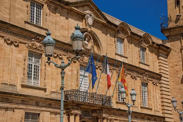Historic building with European flags in Aix-en-Provence during a private guided walking tour.