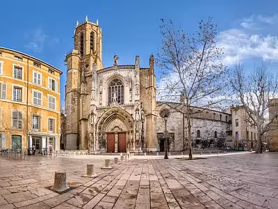 Gothic facade of Aix-en-Provence Cathedral on a sunny cobblestone square in the old town