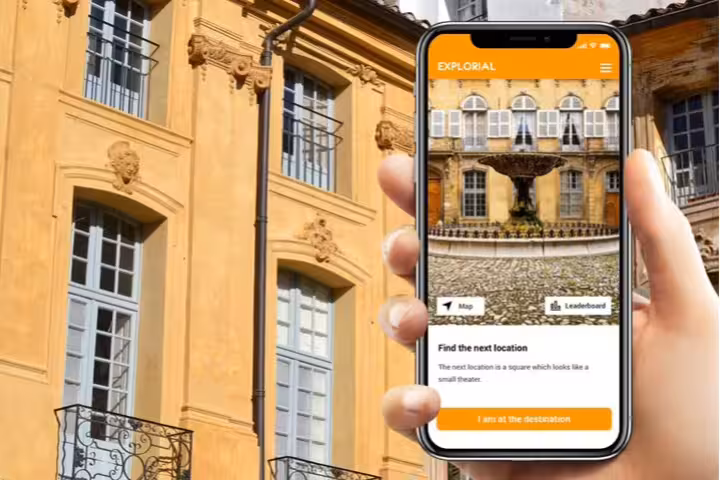 Phone app guiding Aix-en-Provence scavenger hunt tour with map and next clue beside historic buildings